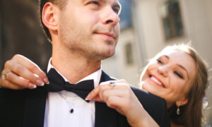 Bride hugging groom from behind